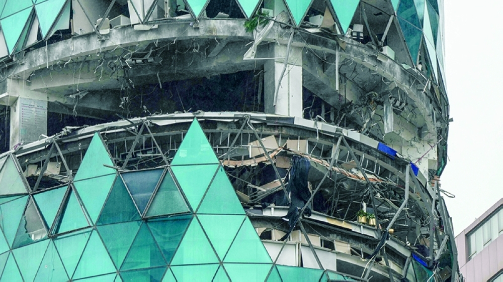 A photograph shows a damaged building in the aftermath of a drone strike in the Seef district of Manama on Tuesday. - AFP