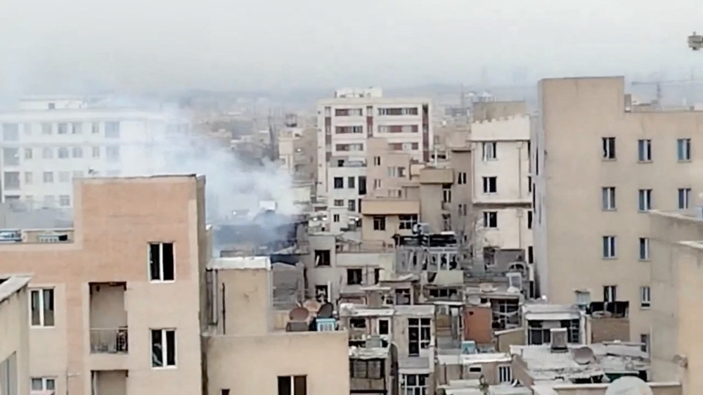 Smoke rises from a building following a reported strike, amid the U.S.-Israeli conflict with Iran, in Tehran