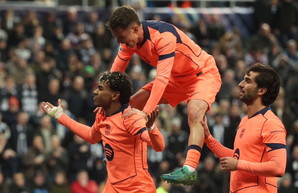   FC Barcelona's Lamine Yamal celebrates scoring their first goal with Marc Casado and Ferran Torres  