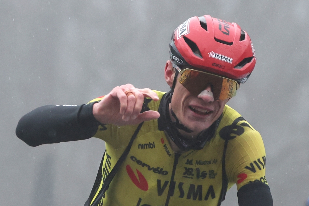 Lease a Bike's Danish rider Jonas Vingegaard celebrates as he crosses crossing the finish