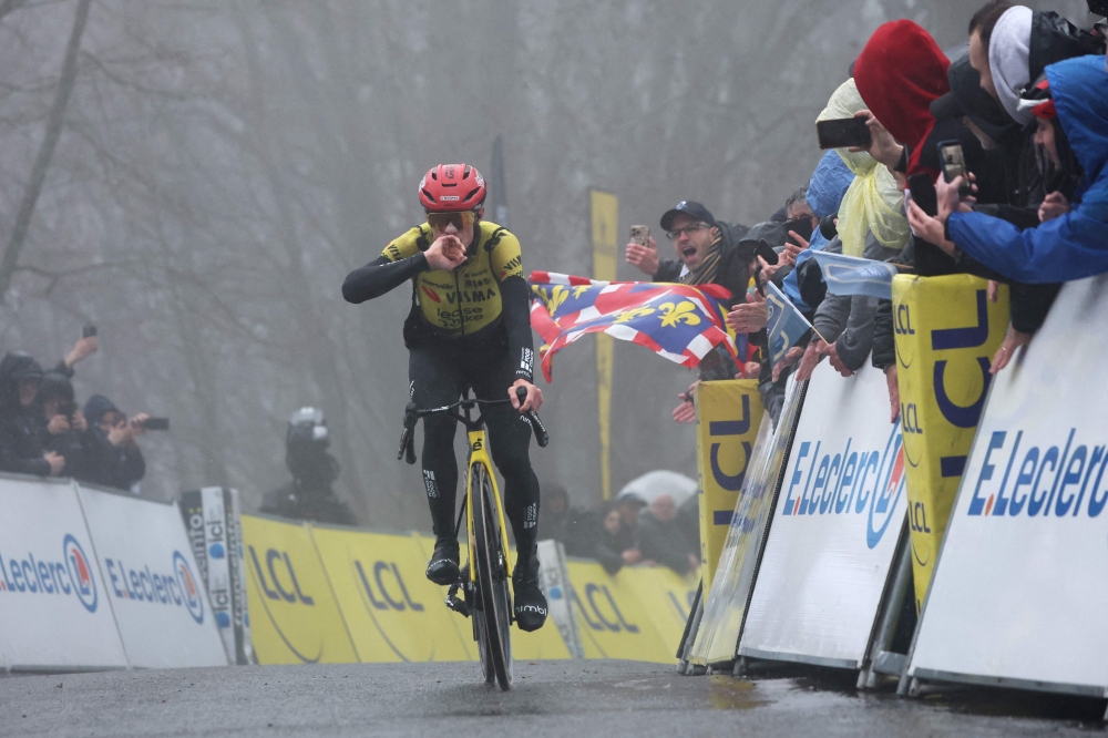 Lease a Bike's Danish rider Jonas Vingegaard celebrates as he crosses crossing the finish to win the 4th stage of the Paris-Nice cycling race
