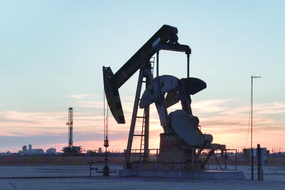 A drone view of a pump jack and drilling rig south of Midland, Texas, US June 11, 2025. REUTERS/Eli Hartman Purchase Licensing Rights, opens new tab.