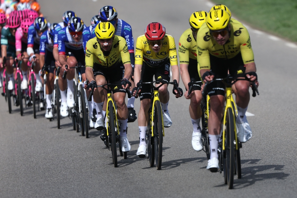 Lease a Bike's Danish rider Jonas Vingegaard (C) and his teammates lead the pack 