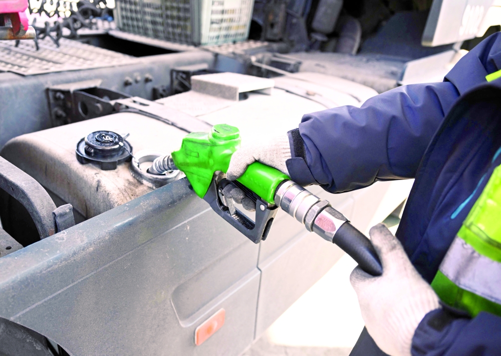 A man fills up a truck at a petrol station of an Inland Container Depot (ICD) terminal in Uiwang, South Korea. — AFP