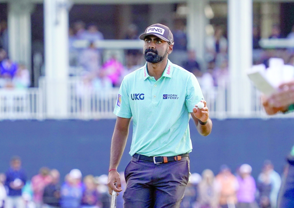 Sahith Theegala acknowledges the crowd after his putt on the 17th green during the second round of the Players Championship golf tournament. — Imagn Images