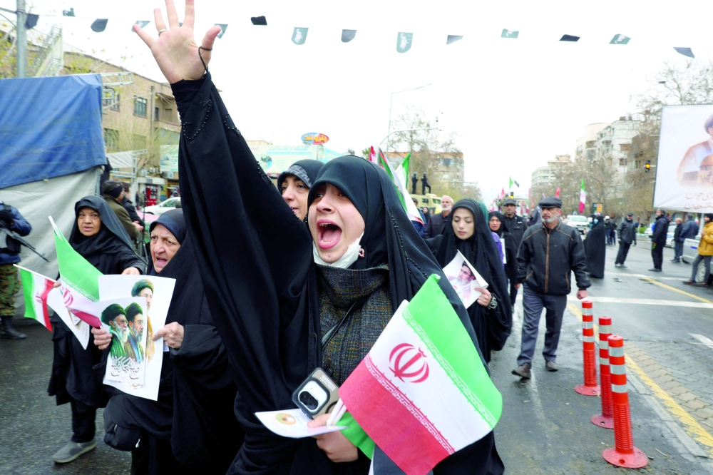 An Iranian woman reacts as she takes part in the Jerusalem Day rally in Tehran. — AFP