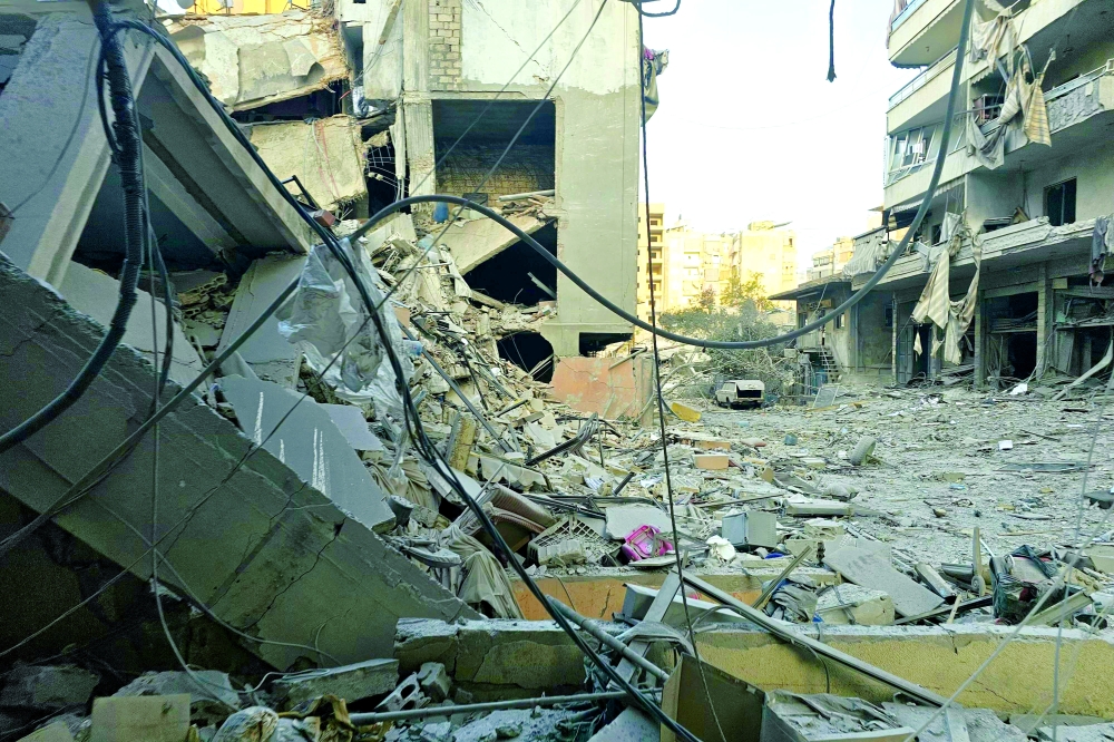 Debris from destroyed buildings blocks the road at the site of an overnight Israeli airstrike that targeted Beirut southern suburbs, in the Hadath neighbourhood, on March 13, 2026. Israel continued striking Beirut as it threatened to expand operations and seize territory in Lebanon if the militant group Hezbollah did not stop its attacks. (Photo by AFP) / Attention editors: AFP covers the war in the Middle East through its extensive regional network, including bureaus in Tehran, Jerusalem and several neighbouring countries. Since the start of the conflict, journalists have been working under increasingly restrictive conditions. Authorities in several countries have limited reporters' movements, photo and live video coverage from sensitive locations. Some governments and armed groups have banned images of missile or drone strikes and other security-related sites.