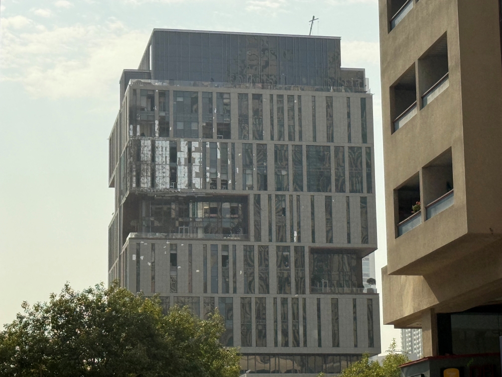 A damaged building in DIFC Dubai, after debris from a successful interception caused minor damage to the facade, amid the U.S.-Israeli conflict with Iran, in Dubai
