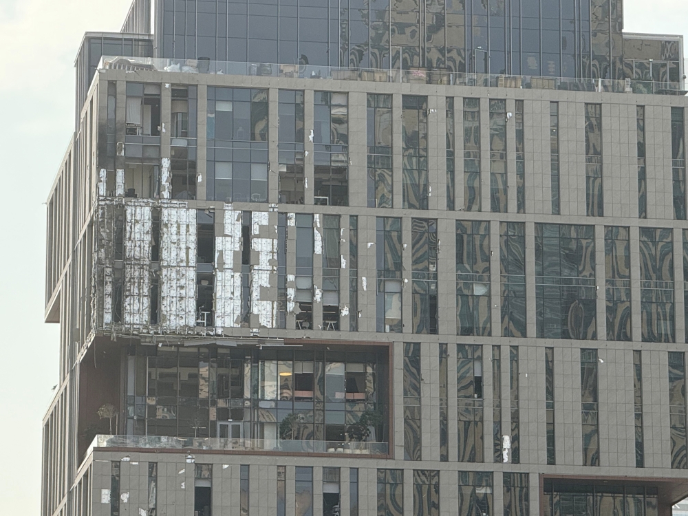 A damaged building in DIFC Dubai, after debris from a successful interception caused minor damage to the facade, amid the U.S.-Israeli conflict with Iran, in Dubai