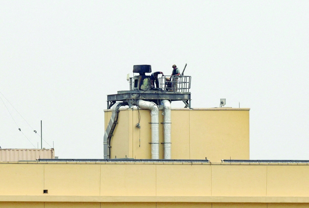 US soldiers inspect a site at the US Embassy, after a missile attack, in Baghdad. — Reuters