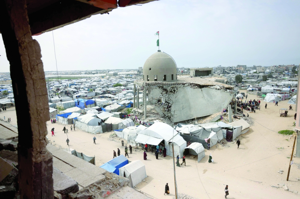 Palestinians pray outside the Al Talbani Mosque, destroyed by the Israeli military in Khan Yunis. — AFP