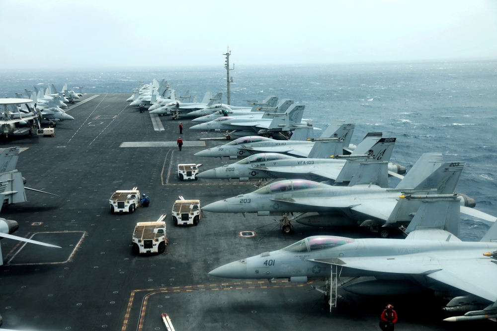 F/A-18F aircrafts are seen on the deck of USS Abraham Lincoln in the Sea of Oman near the Strait of Hormuz 