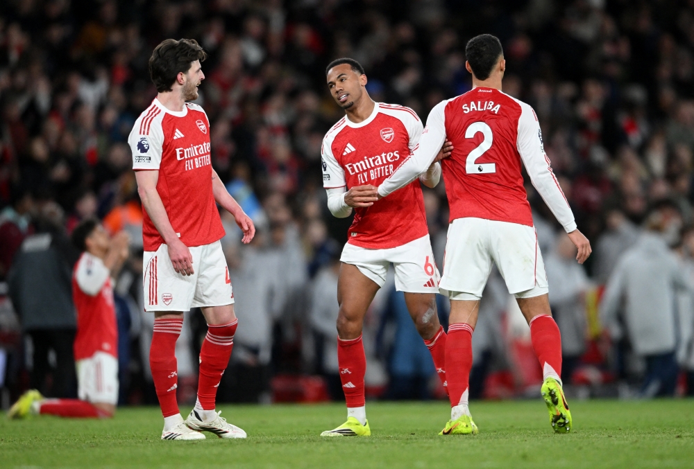  Arsenal's William Saliba, Gabriel Magalhaes and Declan Rice celebrate after the match  