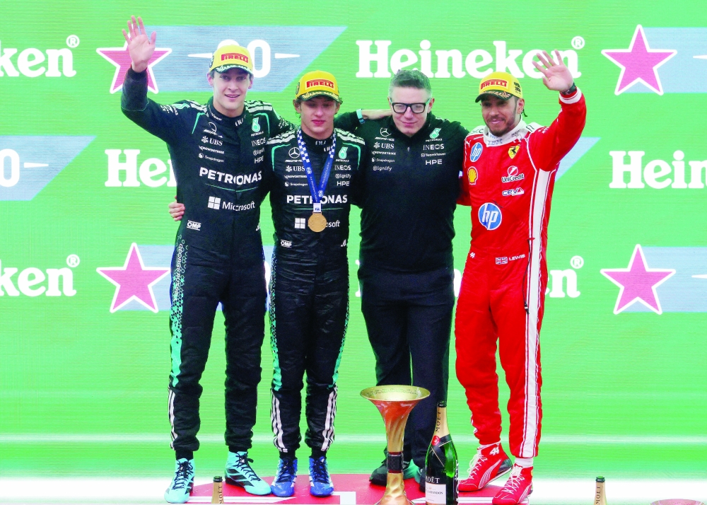  Mercedes' Andrea Kimi Antonelli celebrates on the podium after winning the Chinese Grand Prix alongside second placed Mercedes' George Russell and third placed Ferrari's Lewis Hamilton. — Reuters