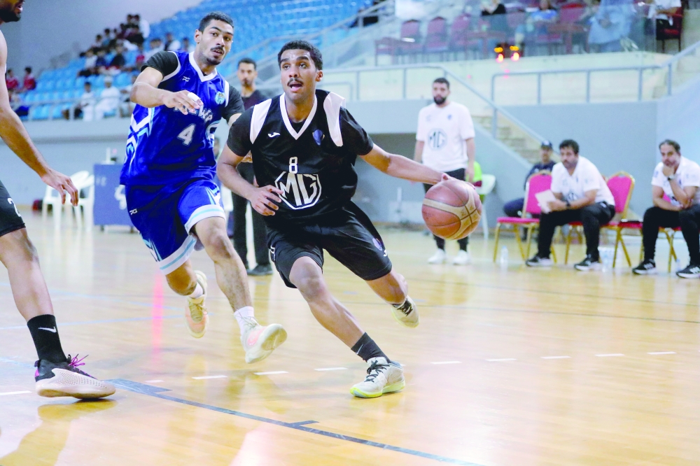 Al Amerat’s player drives hard to the basket under close pressure from Nizwa. — Ammar al Musafir