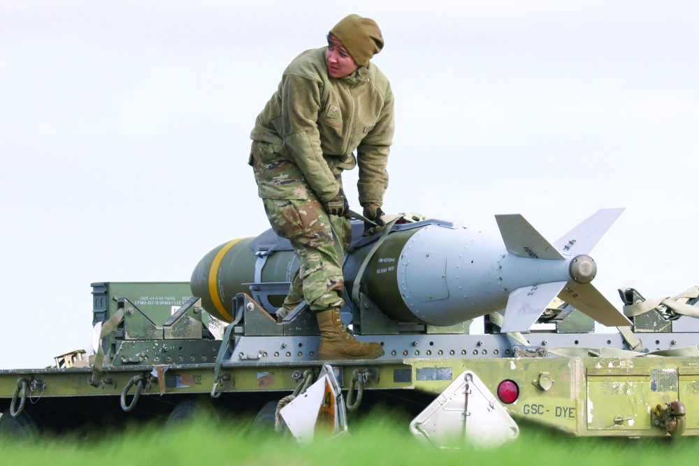 A member of the ground crew works with munitions in Fairford, Britain. — Reuters 