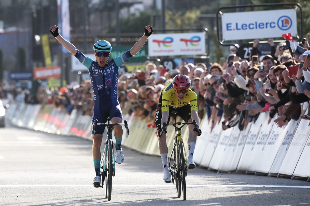 Victorious' French rider Lenny Martinez celebrates as he crosses the finish ahead of Team Visma - Lease a Bike's Danish rider Jonas Vingegaard (R)