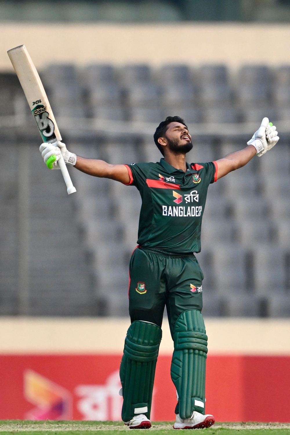 Bangladesh's Tanzid Hasan Tamim celebrates after scoring a century (100 runs) during the third one-day international (ODI) cricket match between Bangladesh and Pakistan 
