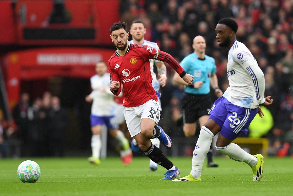   Manchester United's Bruno Fernandes in action with Aston Villa's Lamare Bogarde  