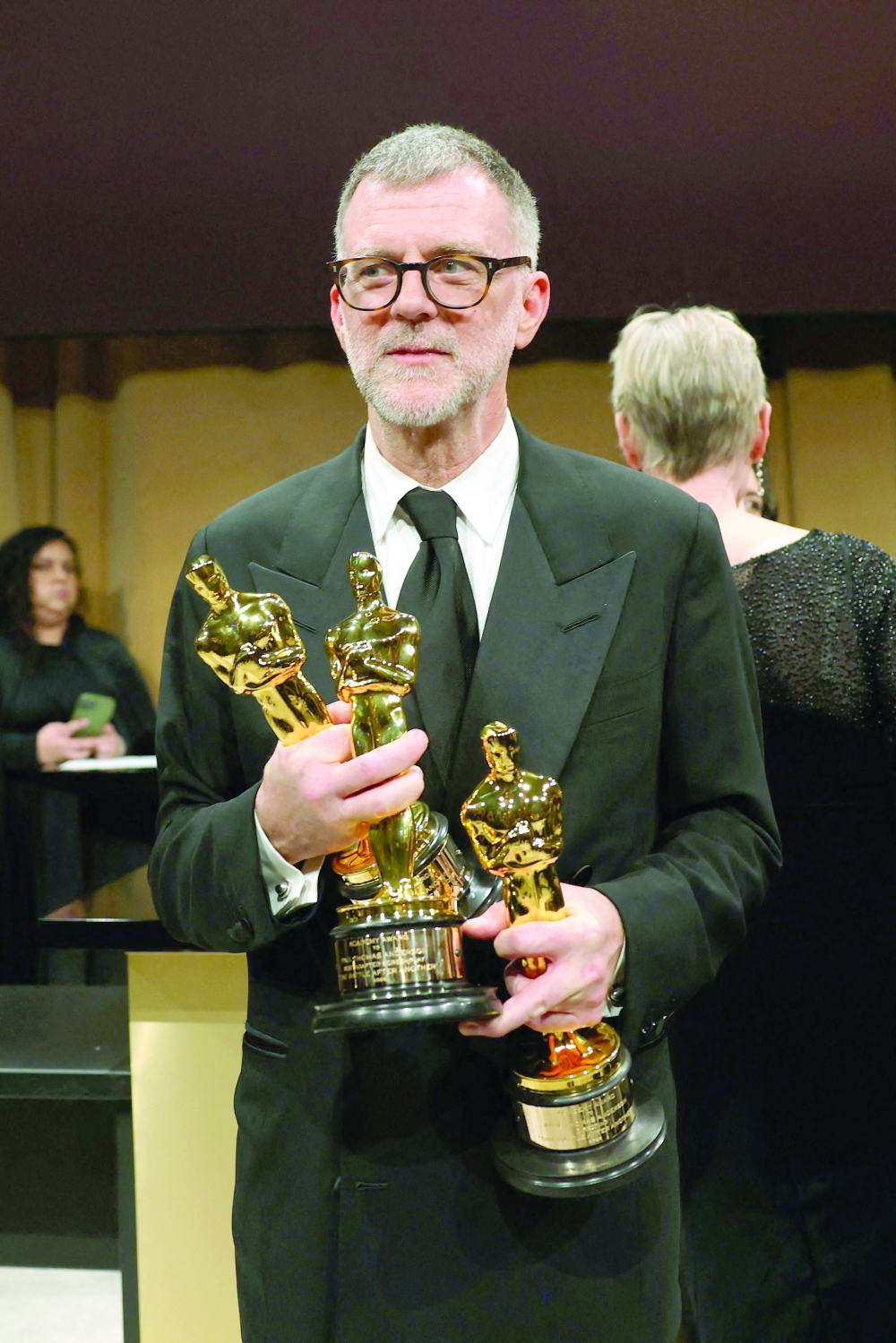 Paul Thomas Anderson stands with his Oscars for Best Picture, Best Adapted Screenplay and Best Director for "One Battle After Another"  during the 98th Annual Academy Awards Governors Ball at the Dolby Theatre in Hollywood, California. — Reuters