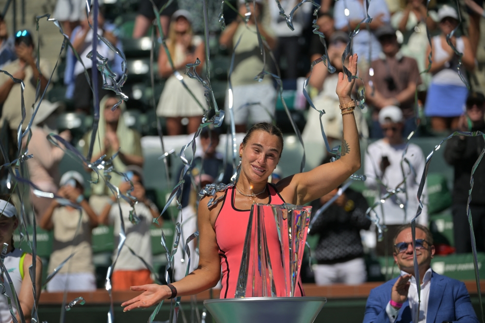 Aryna Sabalenka (BEL) celebrates with the championship trophy after winning the women’s final of the BNP Paribas Open defeating Elena Rybakina (KAZ). — Imagn Images