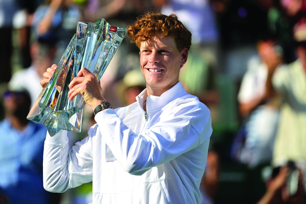 Jannik Sinner (ITA) celebrates with the championship trophy after he defeated Daniil Medvedev (RUS). — Imagn Images 