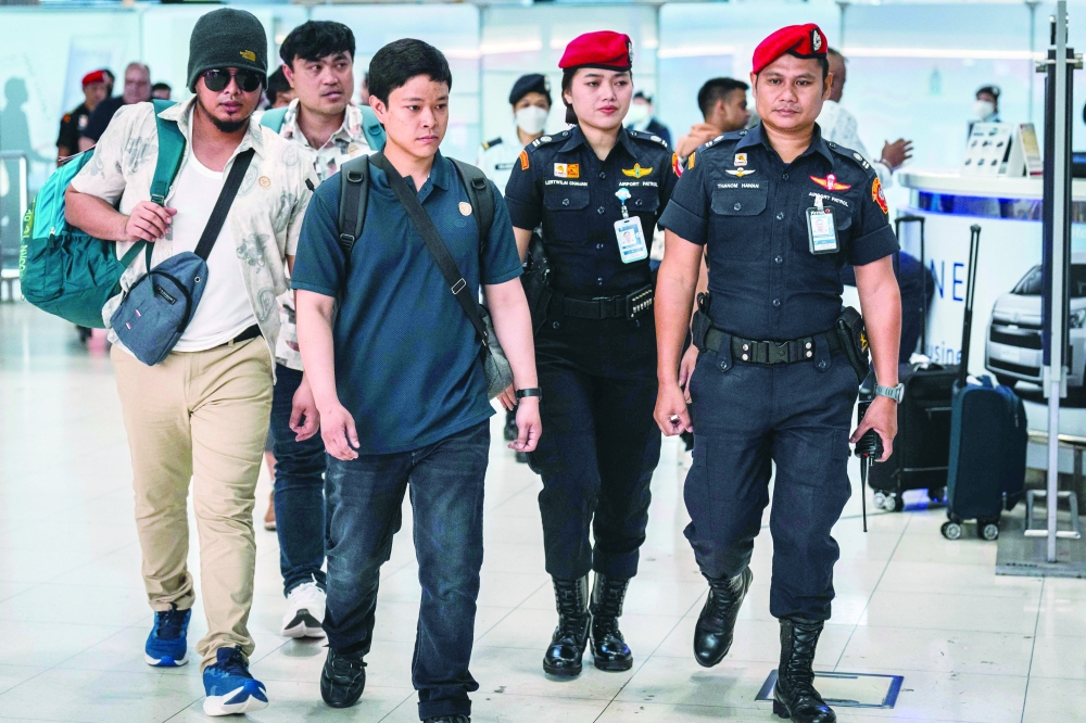 Thai crew members arrive at Suvarnabhumi International Airport, in Bangkok. — AFP