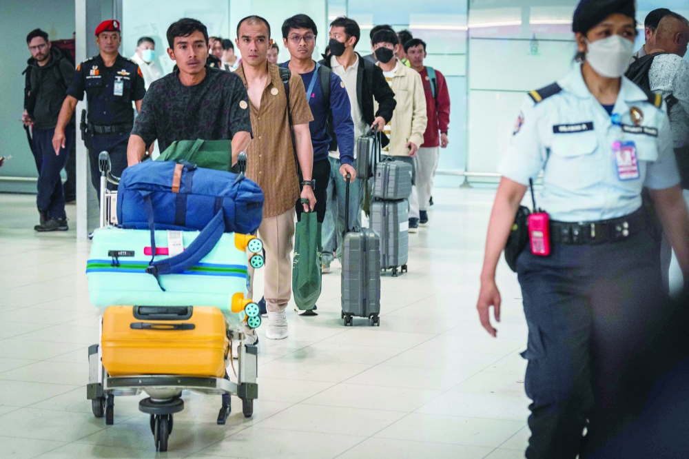 Thai crew members arrive at Suvarnabhumi International Airport, in Bangkok. — AFP