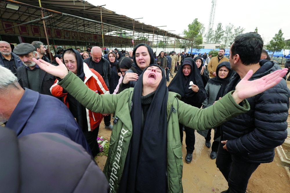 Relatives react during funeral at Behesht-e Zahra cemetery, in Tehran. — Reuters
