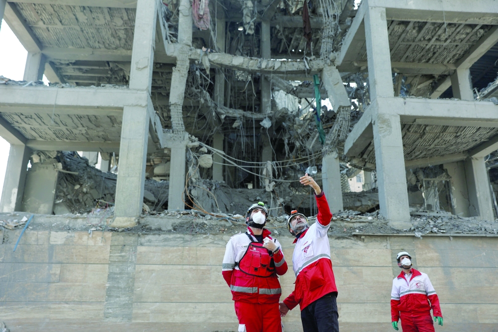 Red Crescent rescue team works at a building that was damaged by a strike in Tehran, Iran, on Tuesday. - Reuters