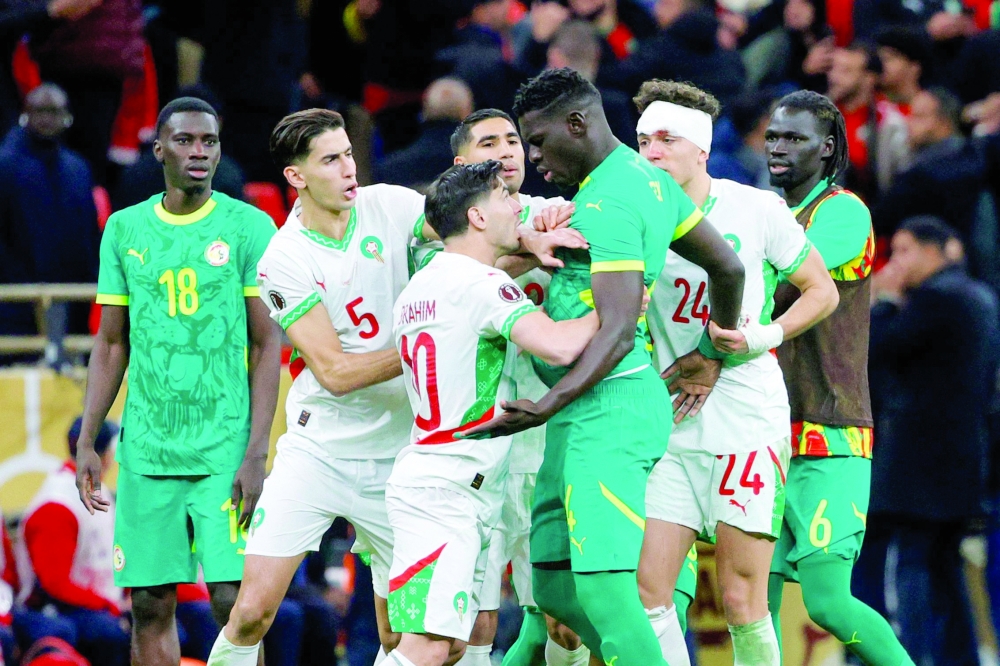 Senegal and Morocco players clash during the Africa Cup of Nations (CAN) final football match between Senegal and Morocco at the Prince Moulay Abdellah Stadium in Rabat on January 18, 2026. Senegal was stripped of its Africa Cup of Nations title by the Confederation of African Football (CAF) over its players' walk-off during the final, with Morocco declared champions, CAF announced on March 17, 2026. CAF confirmed the appeal by the Royal Moroccan Football Federation was upheld, overturning the earlier CAF Disciplinary Board decision that had allowed Senegal to keep their victory. (Photo by Abdel Majid BZIOUAT / AFP)