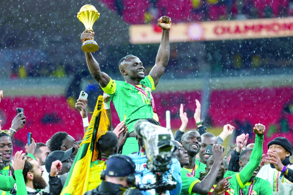 Senegal's forward #10 Sadio Mane celebrates with the trophy after winning the Africa Cup of Nations (CAN) final football match against Morocco at the Prince Moulay Abdellah Stadium in Rabat on January 18, 2026. Senegal say they will appeal after they were sensationally stripped of the Africa Cup of Nations title on March 18, 2026 and the Confederation of African Football (CAF) instead declared Morocco champions, two months after their chaotic final. (Photo by FRANCK FIFE / AFP)