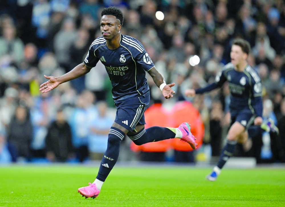 Real Madrid's Brazilian forward #07 Vinicius Junior celebrates scoring the opening goal during the UEFA Champions League, round of 16 second leg football match between Manchester City and Real Madrid at the Etihad Stadium in Manchester, north west England, on March 17, 2026. (Photo by Paul ELLIS / AFP)
