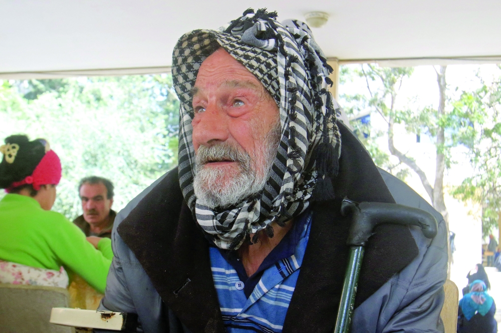 A displaced elderly man from southern Lebanon, looks on in the courtyard of a school turned into a shelter in the southern coastal city of Sidon. — AFP 
