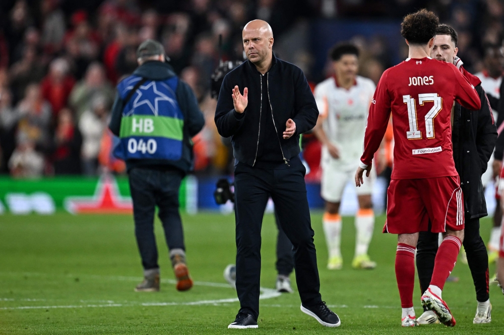 Liverpool's Dutch coach Arne Slot applauds following the victory at the end of the UEFA Champions League