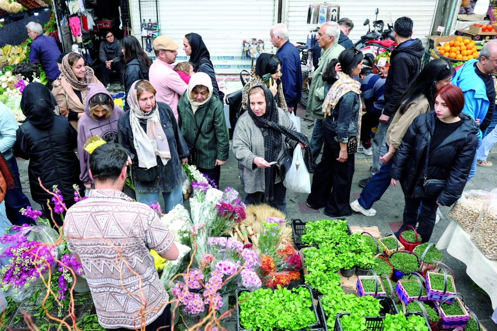 Iranians shop for flowers at the Tajrish Bazaar in northern Tehran. — AFP