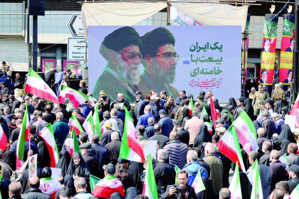 Mourners participate in a procession during the funeral in Iran, in Tehran. — AFP