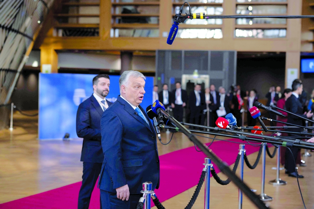 Hungary's Prime Minister Viktor Orban speaks to press as he arrives for a EU Summit at the EU headquarters in Brussels. — AFP
