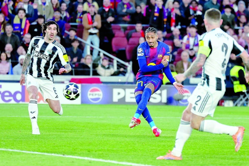 Barcelona's Brazilian forward #11 Raphinha scores his team's first goal during the UEFA Champions League last 16 second leg football match between FC Barcelona and Newcastle United at the Camp Nou stadium in Barcelona, on March 18, 2026.  (Photo by Josep LAGO / AFP)
