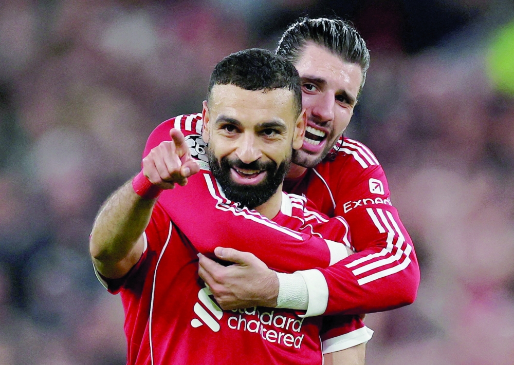 Soccer Football - UEFA Champions League - Round 16 - Second Leg - Liverpool v Galatasaray - Anfield, Liverpool, Britain - March 18, 2026 Liverpool's Mohamed Salah celebrates scoring their fourth goal with Dominik Szoboszlai REUTERS
