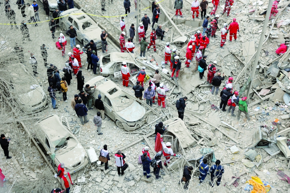 Emergency personnel work at the site of a strike on a residential building, amid the US-Israeli conflict with Iran, in Tehran. - Reuters