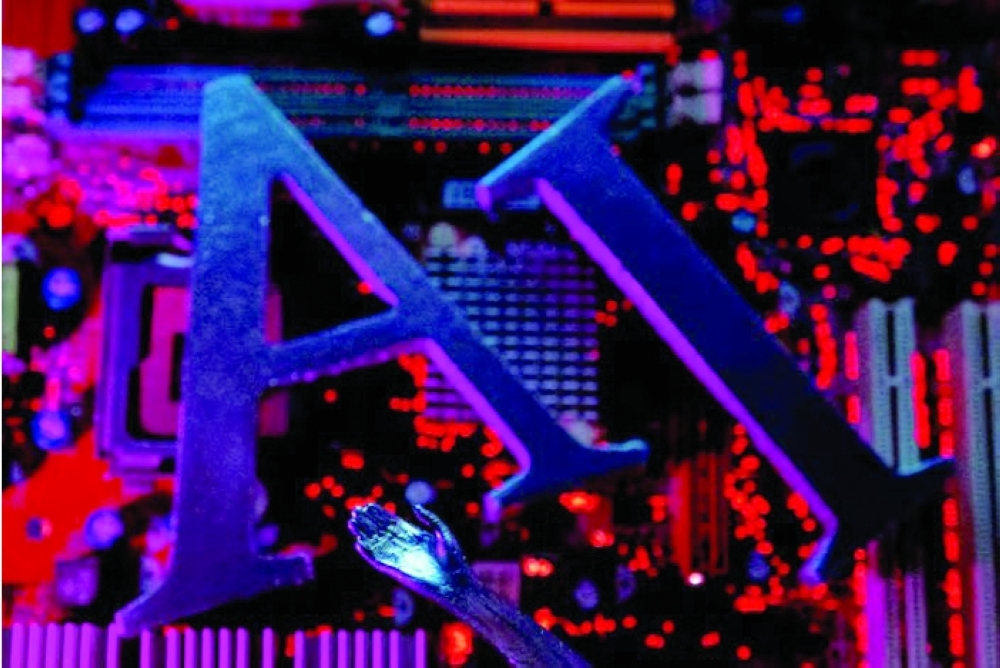 AI letters and robot hand are placed on computer motherboard in this illustration. — Reuters