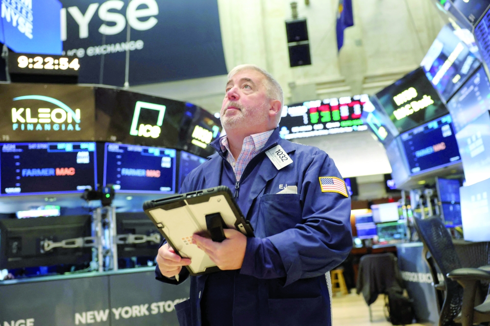 A trader works on the floor of the NYSE at the opening bell in New York. — AFP