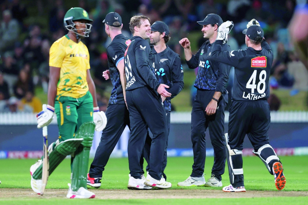 New Zealand's Lockie Ferguson (C) celebrates the wicket of South Africa's Nqobani Mokoena (L) during the second Twenty20 international cricket match between New Zealand and South Africa played at Seddon Park in Hamilton on March 17, 2026. (Photo by Michael Bradley / AFP)

