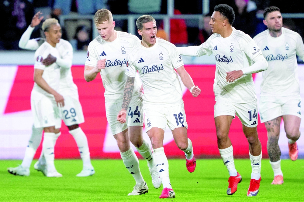 Nottingham Forest players celebrate after Nicolas Dominguez (C) scored the opening goal during the UEFA Europa League football match, last 16 second leg, between FC Midtjylland and Nottingham Forest in Herning, Denmark on March 19, 2026. Denmark OUT
 (Photo by Bo Amstrup / RITZAU SCANPIX / AFP)
