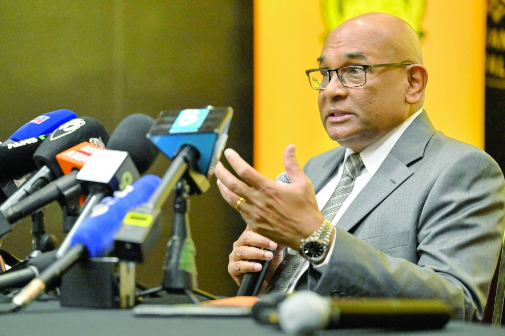 Asian Football Confederation (AFC) general secretary Windsor John (L) speaks during a press conference at the Malaysian football association's headquarters in Kuala Lumpur on March 16, 2026. (Photo by MOHD RASFAN / AFP)
