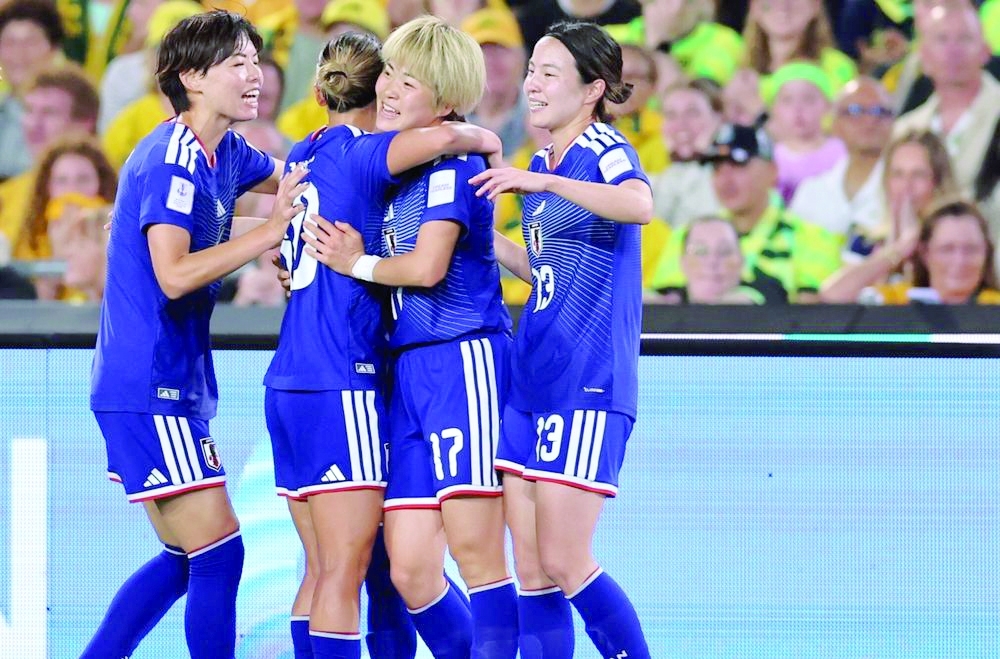 Japan players celebrate their goal against Australia in Sydney.