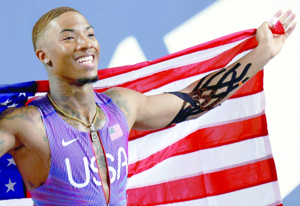 USA's Jordan Anthony displays his country's flag after winning the men's final 60 metres event during the World Athletics Indoor Championships Kujawy Pomorze 2026 in Torun, Poland on March 20, 2026. (Photo by Wojtek RADWANSKI / AFP)
