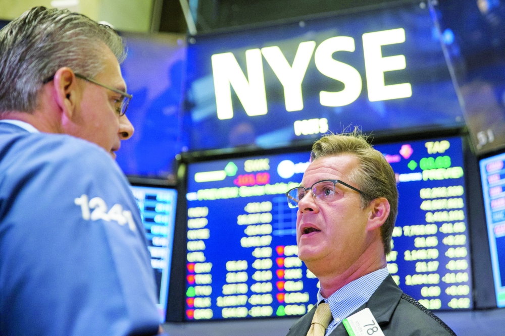 Traders work on the floor of the New York Stock Exchange in New York. — Reuters File