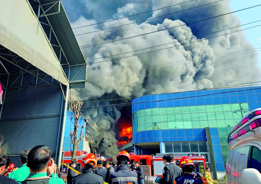 Heavy smoke rises following a fire at a car parts plant in Daejeon. — AFP